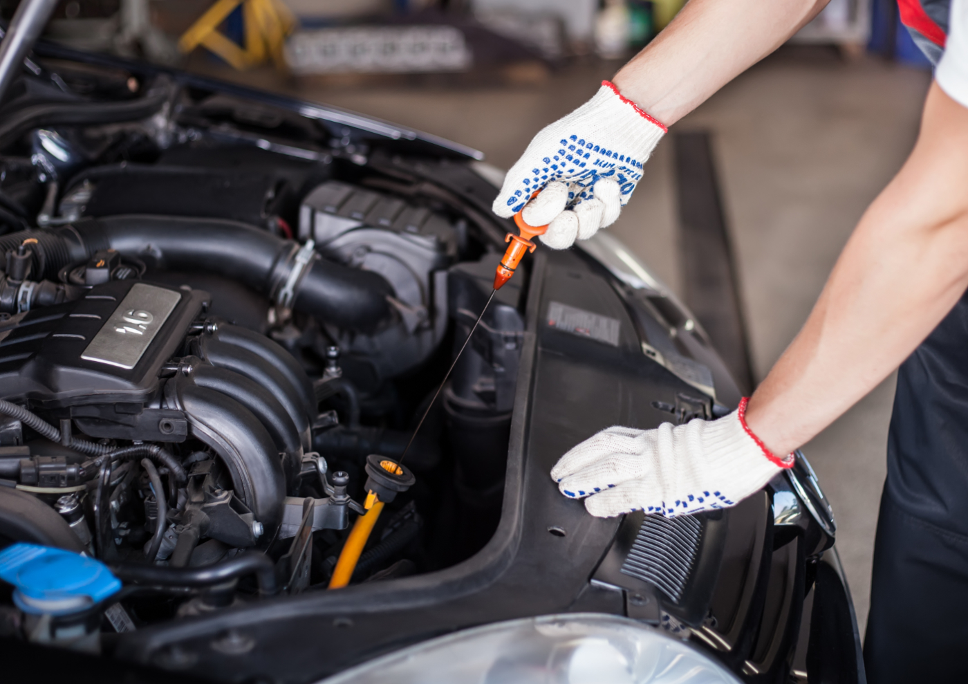 Mechanic checking the bonnet of a vehicle - Car MOT Swindon